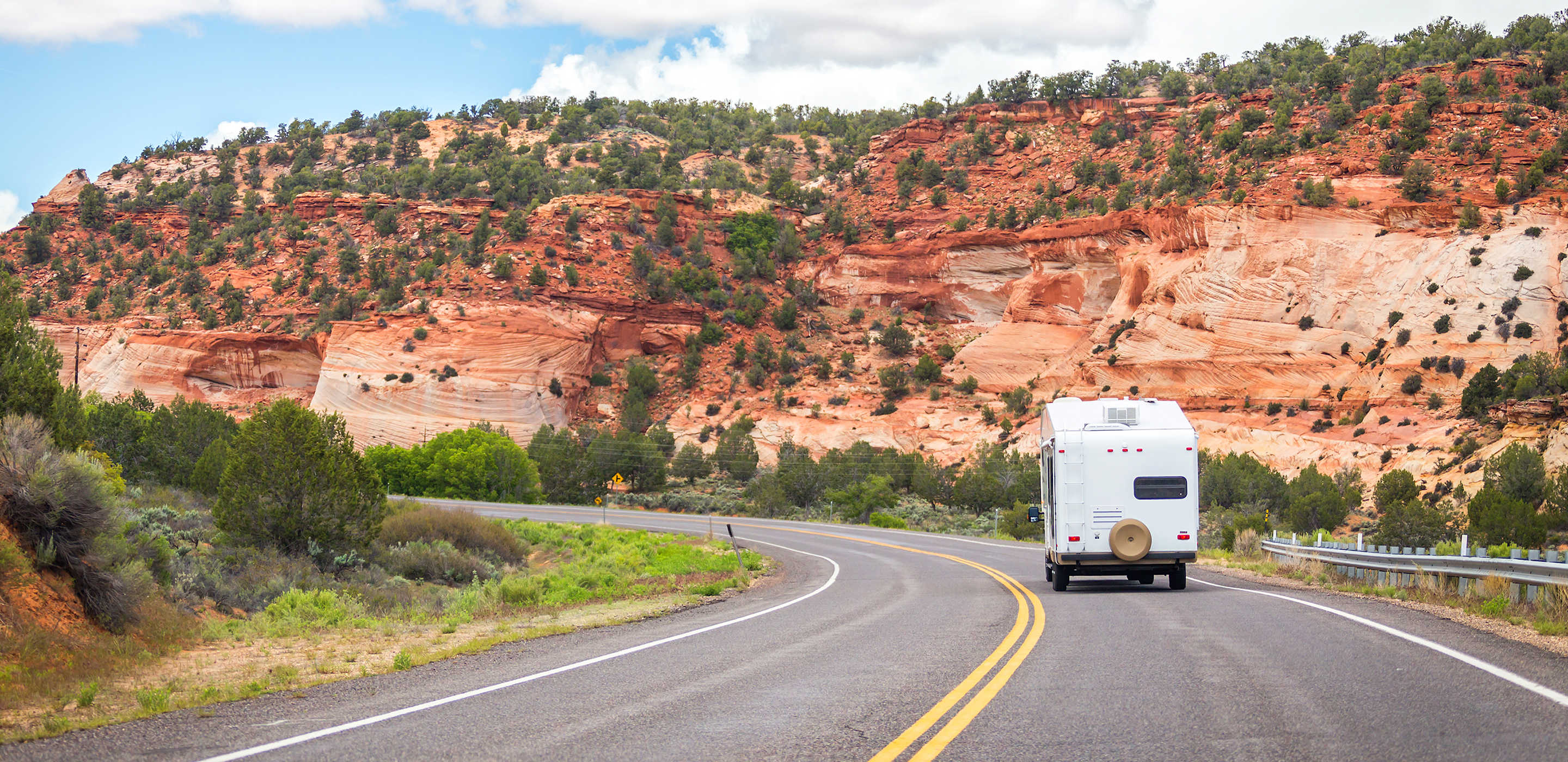 an RV drives on a road through Bryce Canyon National Park, Utah