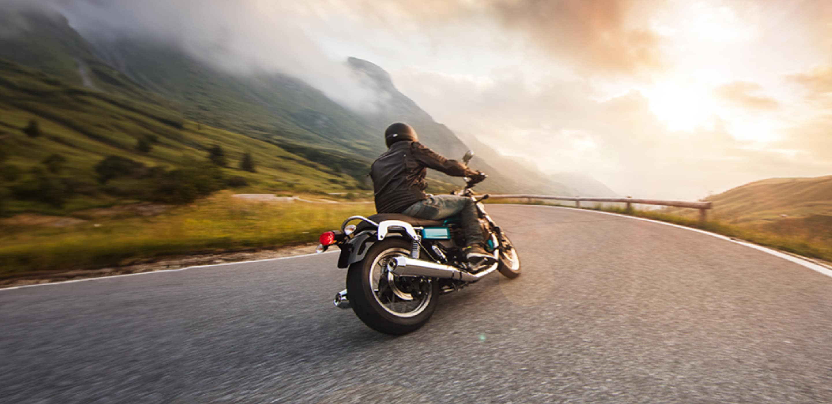 a motorcyclist with AAA motorcycle insurance rides on the highway with a camera mounted to his helmet