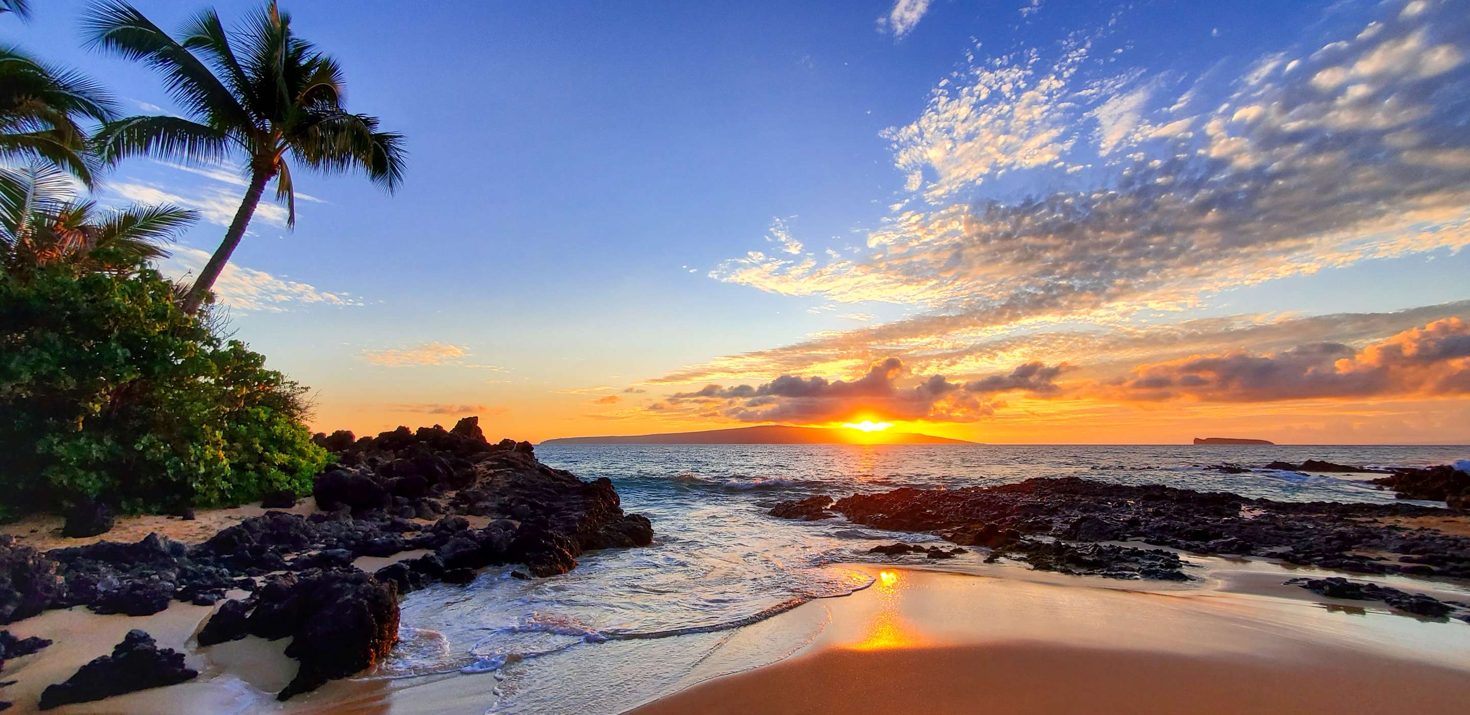sunset over beach in maui hawaii