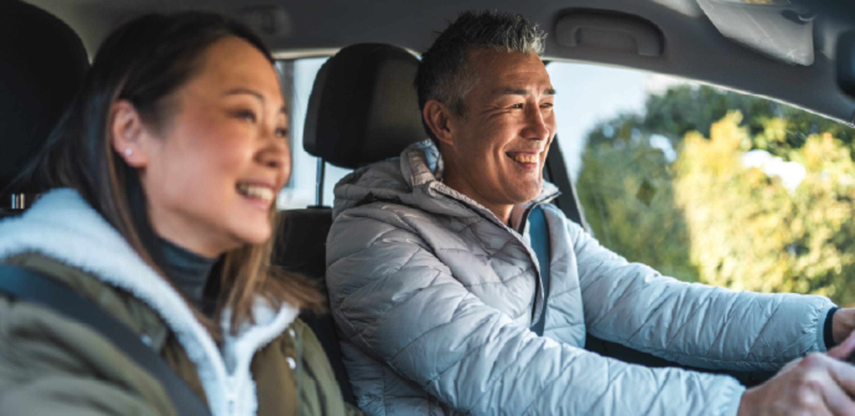 Man and woman driving in car