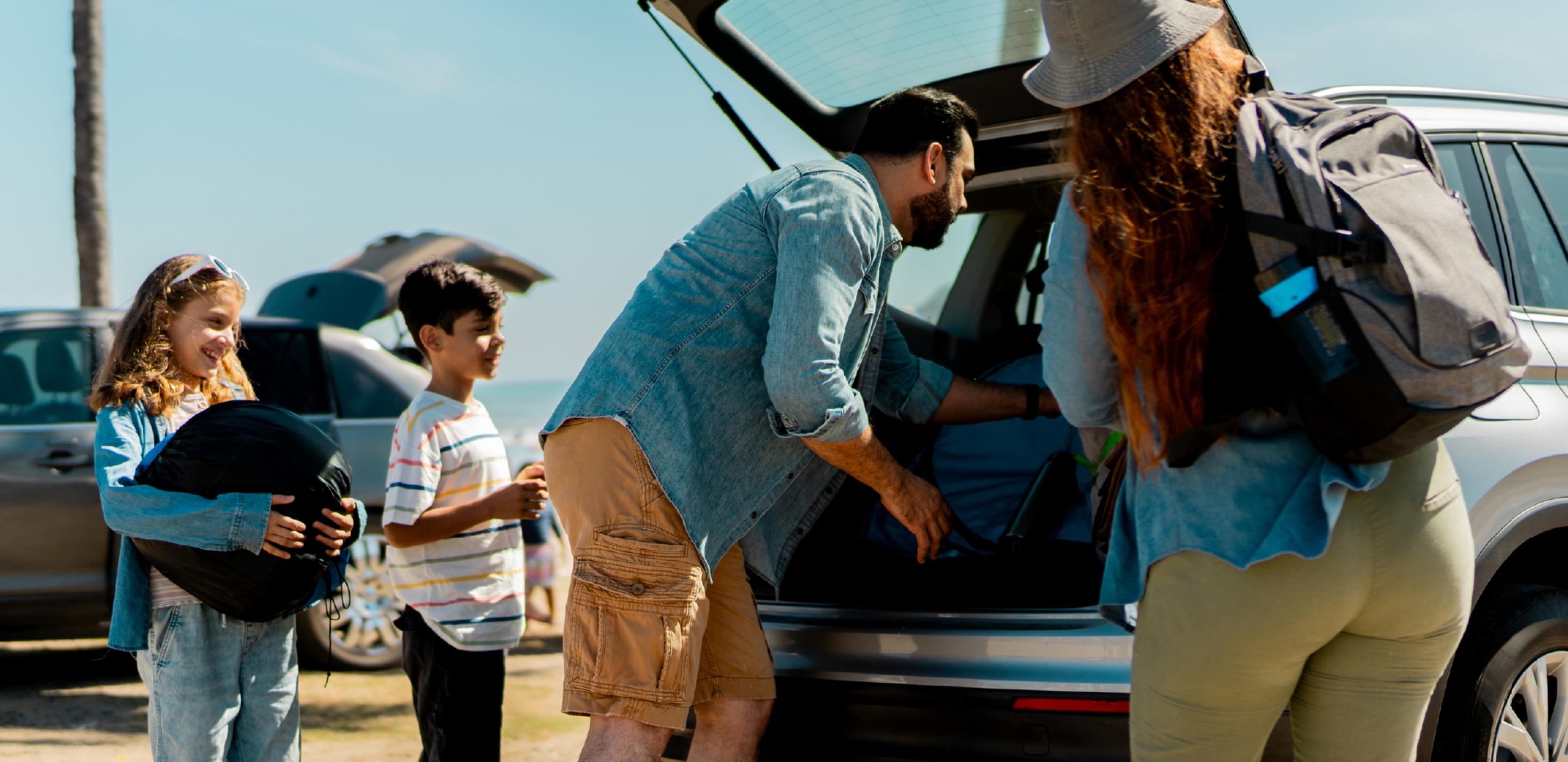 FAMily loading car with beach supplies
