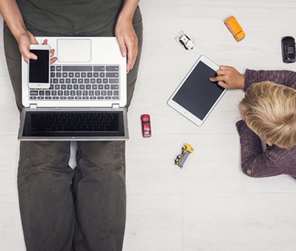 A mother with AAA Identity Champion uses technology at home with her son 