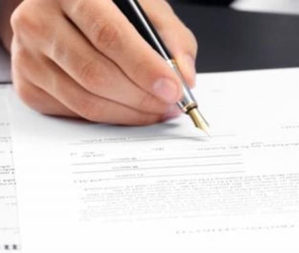 a AAA member signs DMV forms for a notary at the AAA office