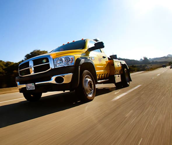 A AAA tow truck on its way to an ERS roadside service call to a car breakdown