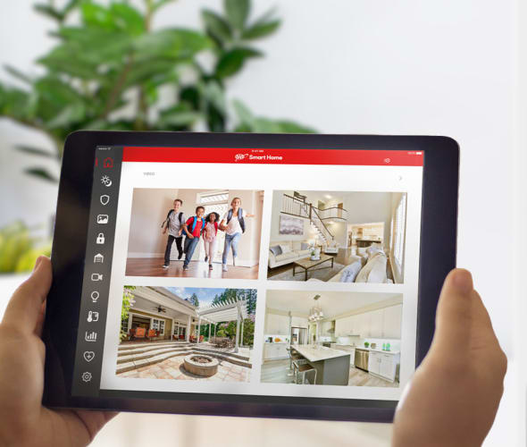 A AAA Smart Home customer monitors her home on a tablet