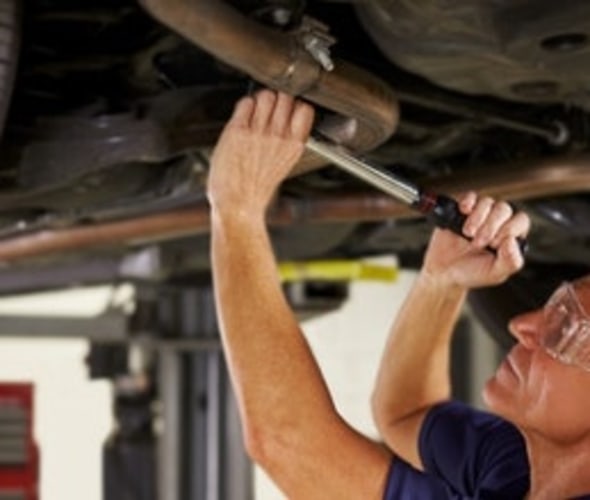 A AAA car mechanic repairs an auto in the shop