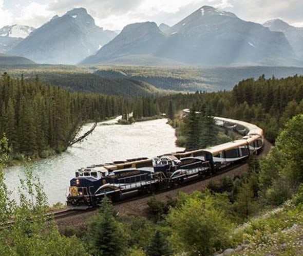 rocky mountaineer train next to a river