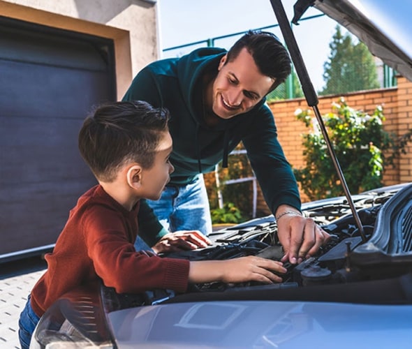 a AAA insurance customer checks the oil levels of his car