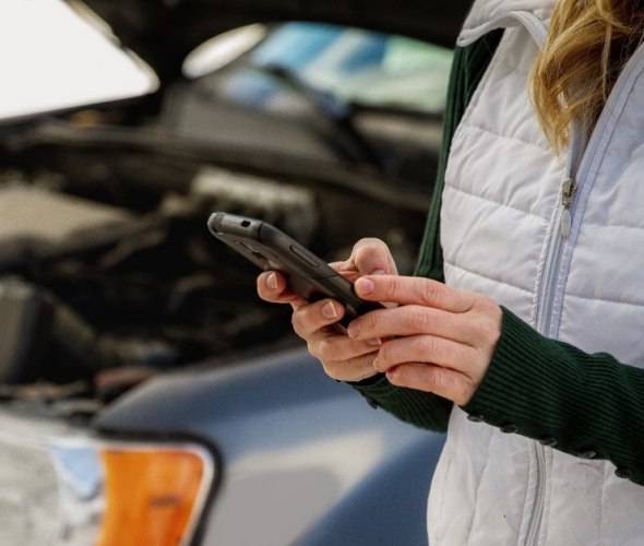 a woman requests AAA roadside service from the AAA mobile app