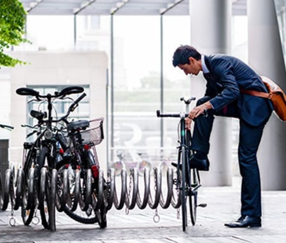 A AAA member locks their bicycle outside an office