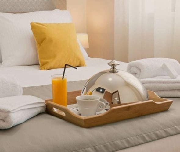 Hotel bed with breakfast tray