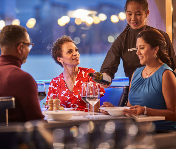 server pouring wine on a uniworld river cruise