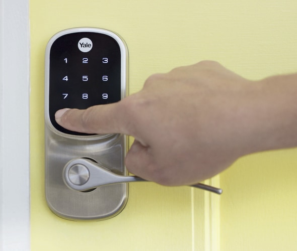 Entering keypad code on security door lock