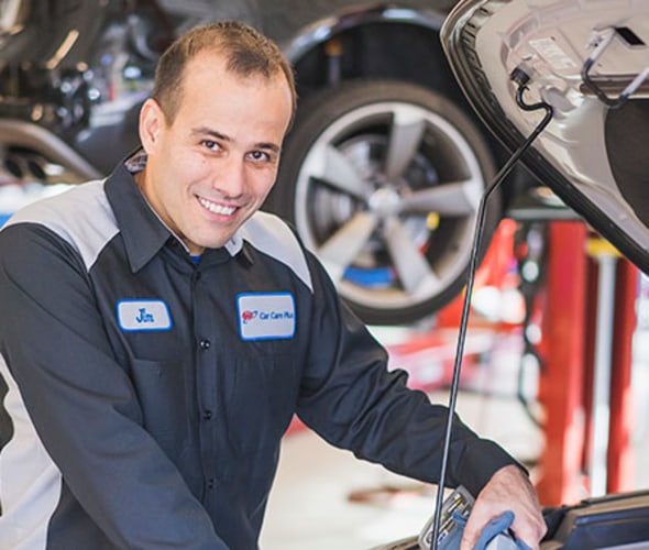 a AAA auto repair technician helps a customer