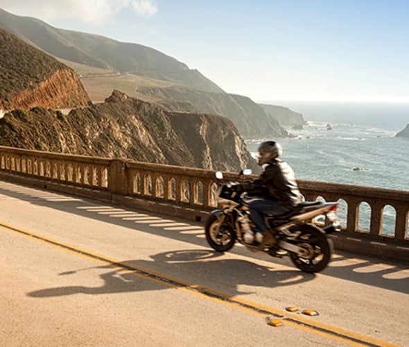 Motorcycle driving alone down the coast of California