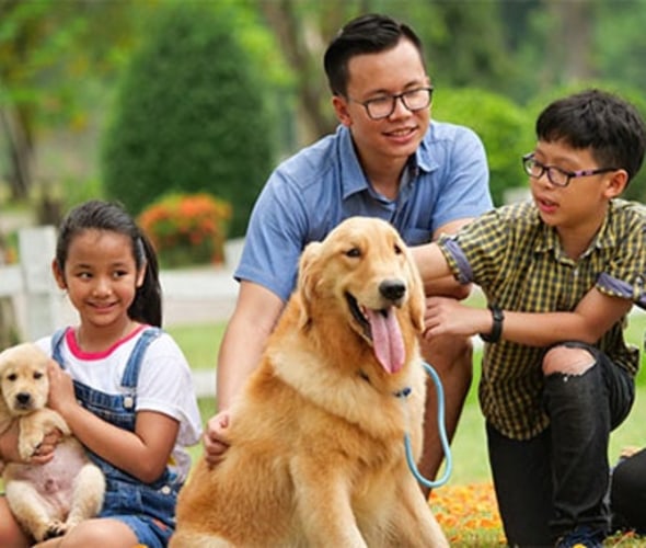 A family with AAA insurance enjoys time together with their dog