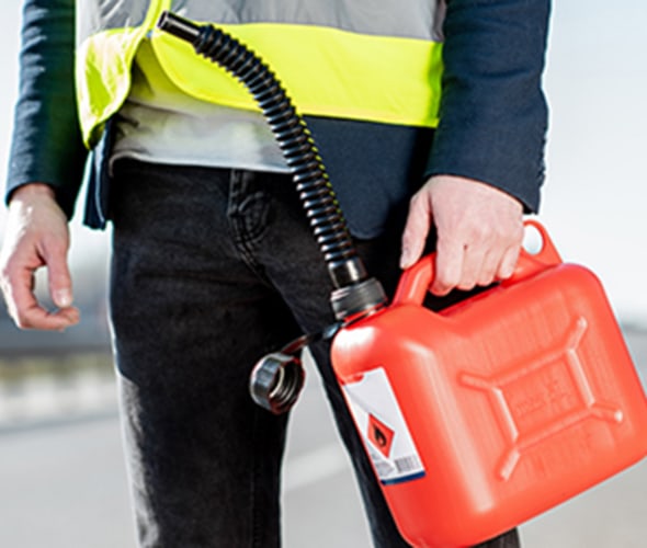 a AAA employee delivers gas to a stranded driver