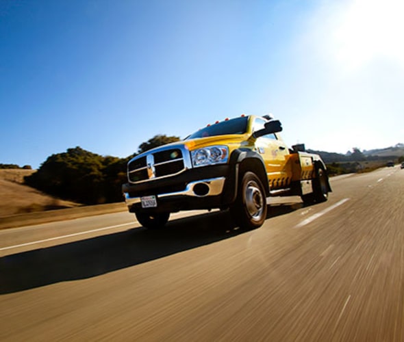 a AAA tow truck on the way to a roadside assistance call