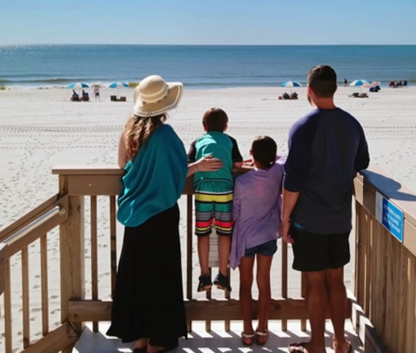 Family on hotel beach stairs booked using Best Western Rewards