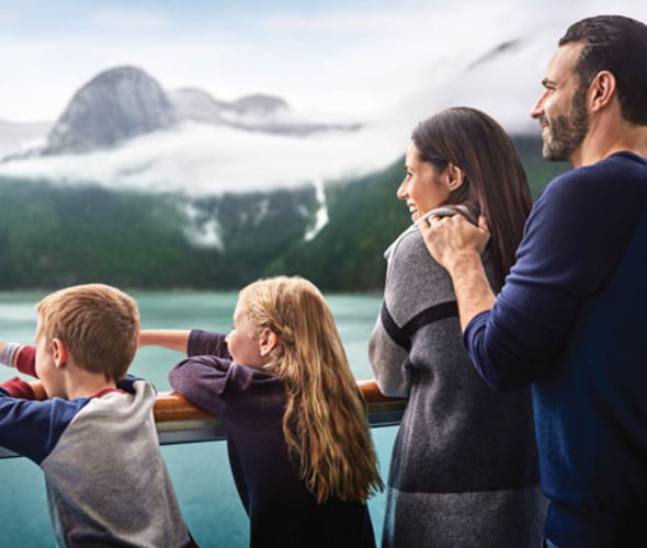 family enjoying the view from deck on a princess alaska cruisetour