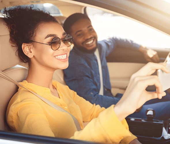 a couple with aaa car insurance takes a selfie on their road trip