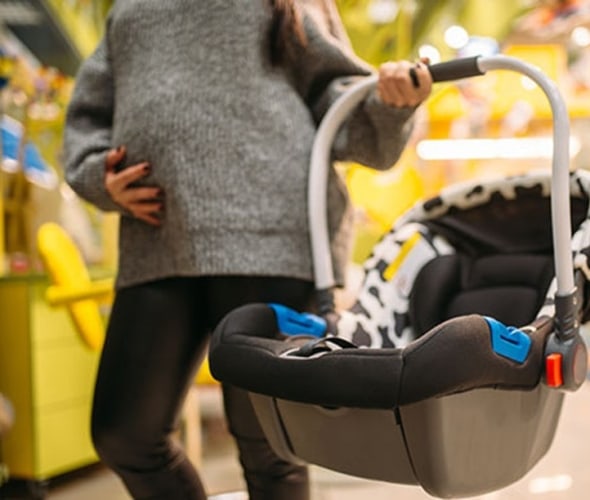an expecting mother shops for a car seat