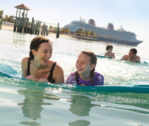 disney cruise line ship and guests at castaway cay