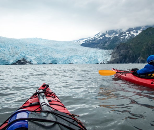 kayak past glaciers on alaska vacations