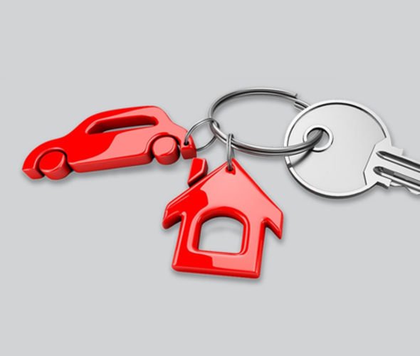keychain in the shape of a house and a car with keys attached