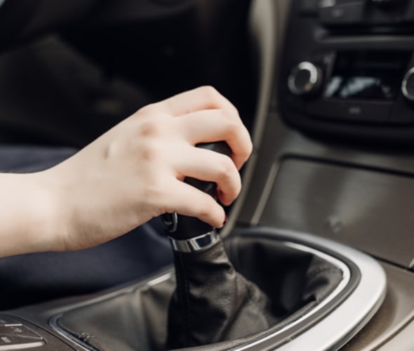 a woman's hand clutches a gearshift in a car