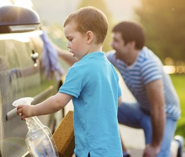 a son helps his father wash a car insured by AAA insurance