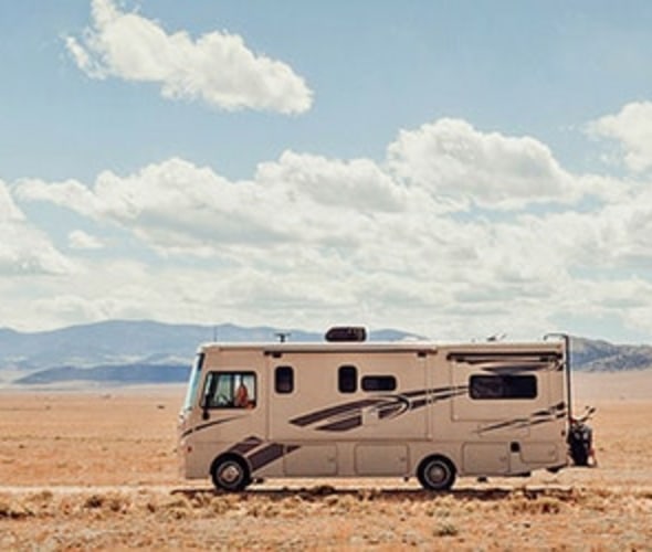 Motorhome RV covered by AAA Insurance driving across the desert