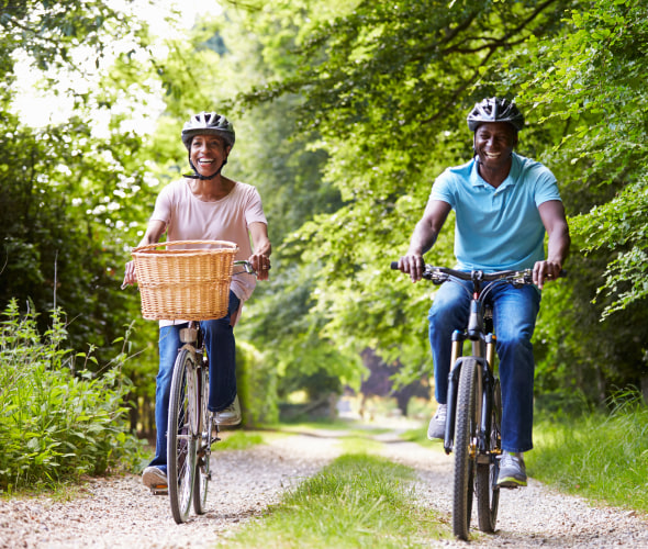 Couple riding bikes on a wooded path