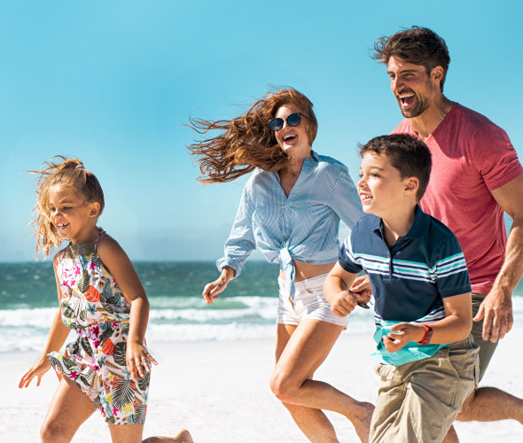 Family running on the beach