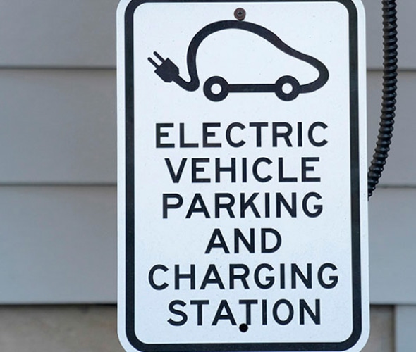 Street sign that says Electric vehicle parking and charging station
