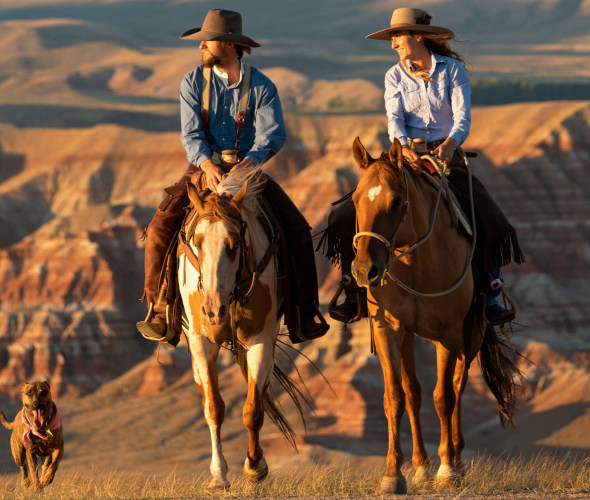 A couple rides horses in Dubois, Wyoming.