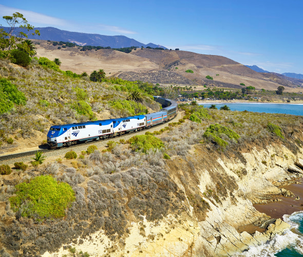 Amtrak train winds along the coast in California.