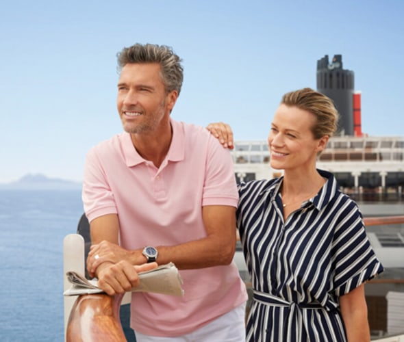 couple on deck of cunard ship enjoying view