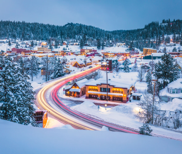 Aerial view of Truckee, California covered in snow at dusk.