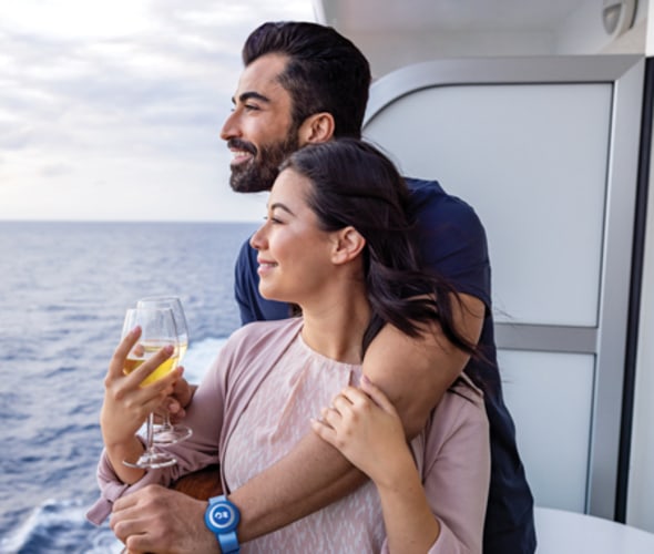couple with wine on balcony of stateroom on princess cruise ship