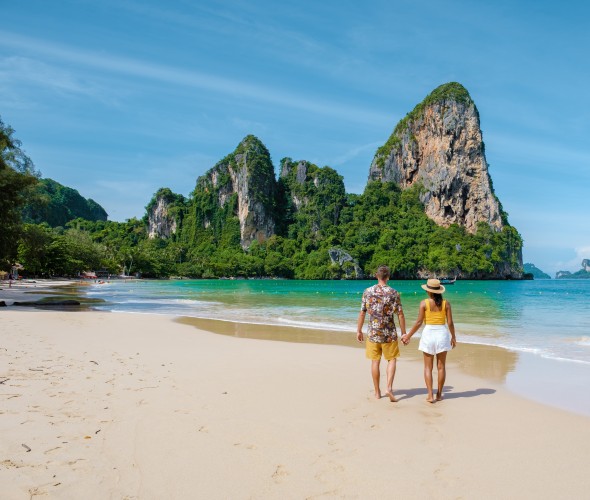 couple walking on a beach in thailand