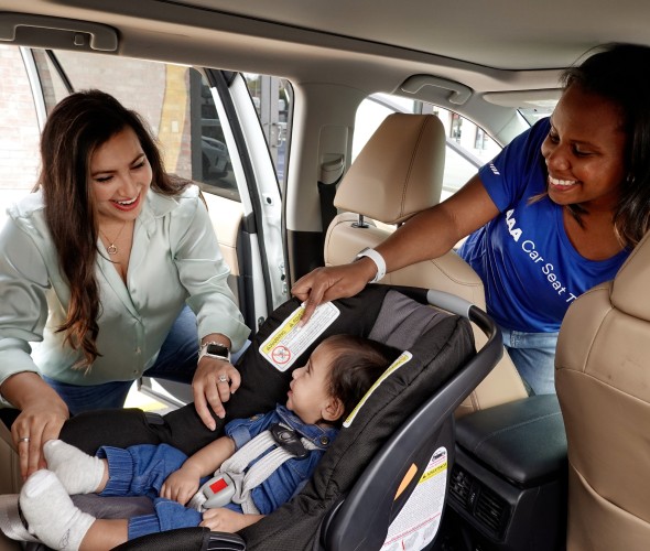 AAA representative performing a car seat inspection
