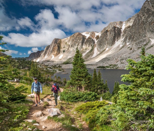 Two hikers climb a trail in the Medicine Bow Wilderness in Wyoming.