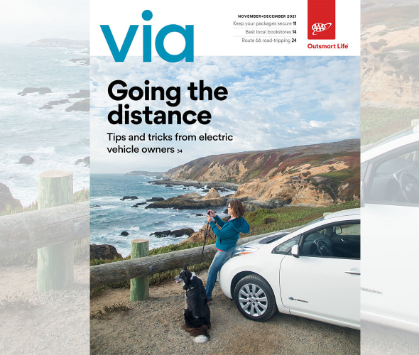 A woman overlooks the Pacifica Ocean alongside her dog and her Nissan Leaf on the cover of Via magazine's November December 2021 issue.