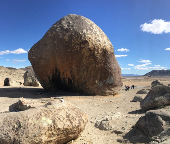 Giant Rock in front of a cloudy blue desert sky in Landers, CA