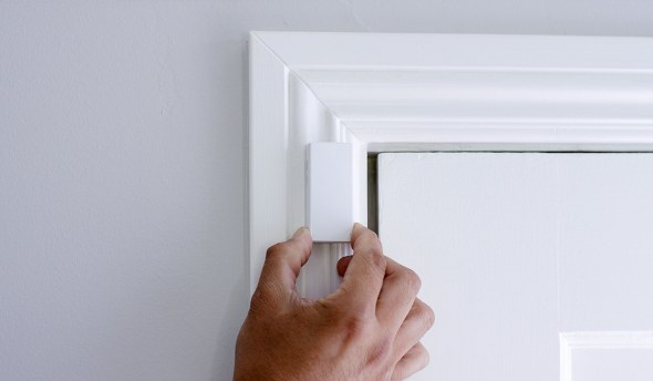 Hand installing door sensor