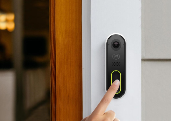 Person ringing smart doorbell