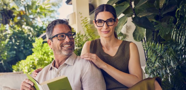 two AAA members smile with LensCrafters glasses on