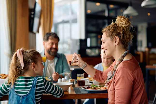 a family eats breakfast at a restaurant