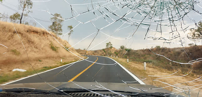 cracked front windshield ready to be replaced by technician